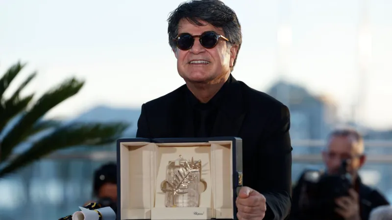 Iran's Palme d'Or-winning director cheered as he arrives home