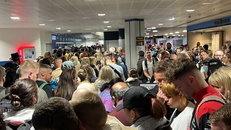 Manchester Airport passengers face long queues after evacuation - BBC News