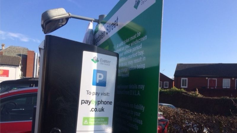 Exeter car park price board hidden behind ticket machines - BBC News