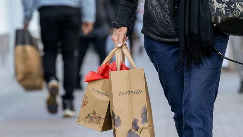 US shopper carrying bags, reflecting economic activity