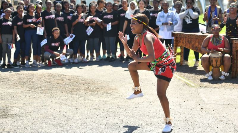A dancer entertains the crowds at the township in Cape Town ahead of the royal visit South Africa