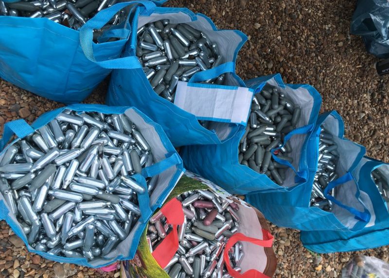 Brighton Pride Beach covered with laughing gas canisters BBC News
