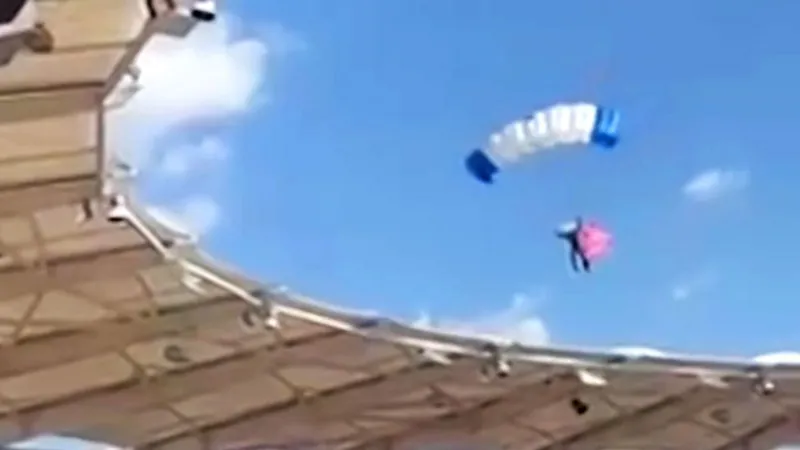 A wide shot of a stadium in Toulouse showing the moments before a parachutist gets caught in the stadium roof.