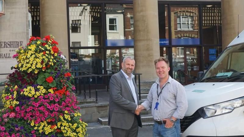 Cllr Dom Morris of Gloucestershire County Council and Simon Woodford, Business Director for Street Lighting at Milestone Infrastructure shake hands. 