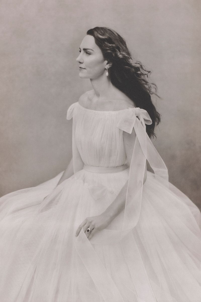Catherine, Princess of Wales wears a white gown and looks off to one side