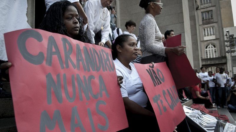 "Carandiru: Never again" and "Don't shut up" read the posters held by demonstrators at the vigil outside the Se Cathedral in Sao Paulo