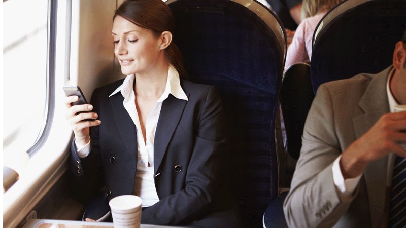 Woman commuter on train with phone