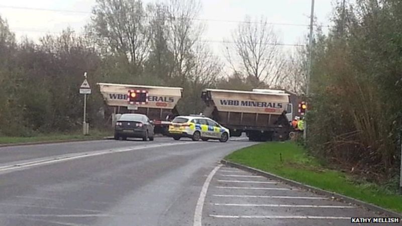 Man arrested after train hits lorry at Norfolk level crossing - BBC News