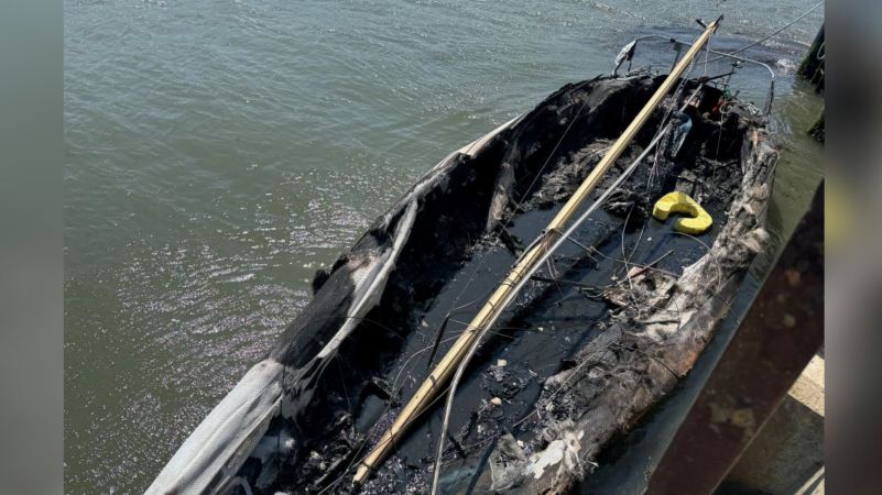 Burnt out boat on the water