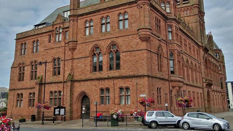 The exterior of Barrow Town Hall, a grand red brick building.