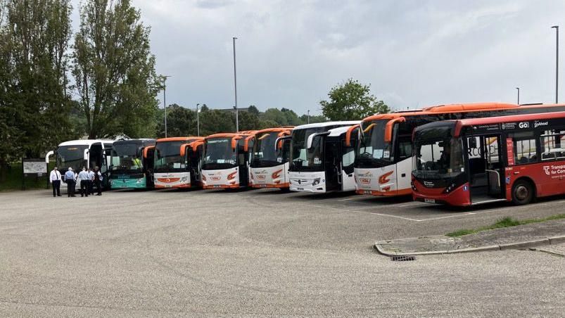 A mixture of visiting coaches and local buses parked at Truro coach park