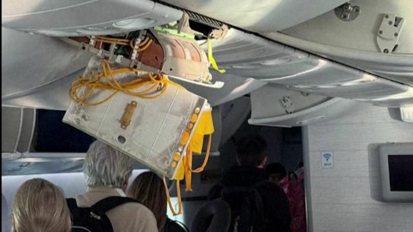 Wires dangle from the overhead luggage compartment
