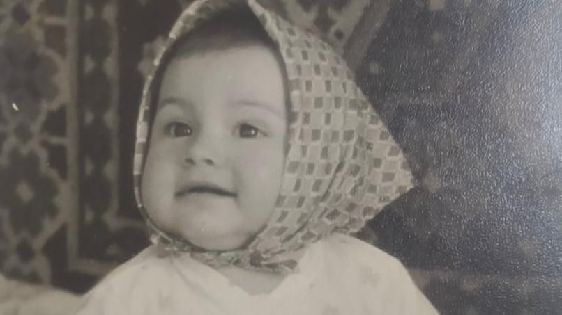 A picture of a little girl with a headscarf 