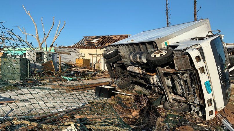 A truck sits on its side following landfall by Hurricane Dorian