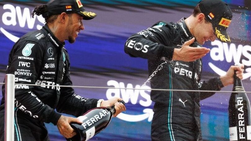Lewis Hamilton sprays George Russell with champagne