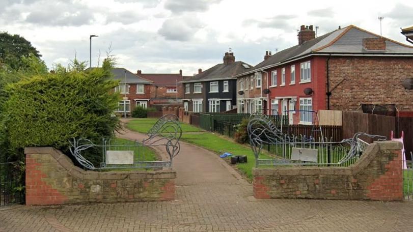 A row of houses with a path in front