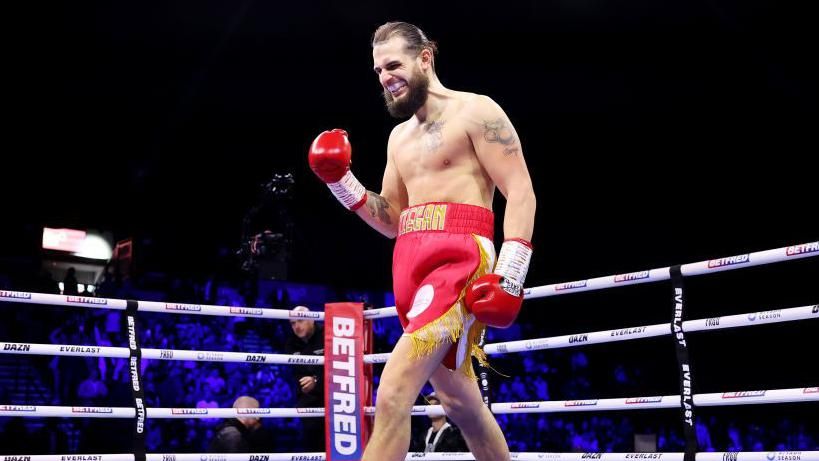 Liam Cameron punches the air after a win in the ring