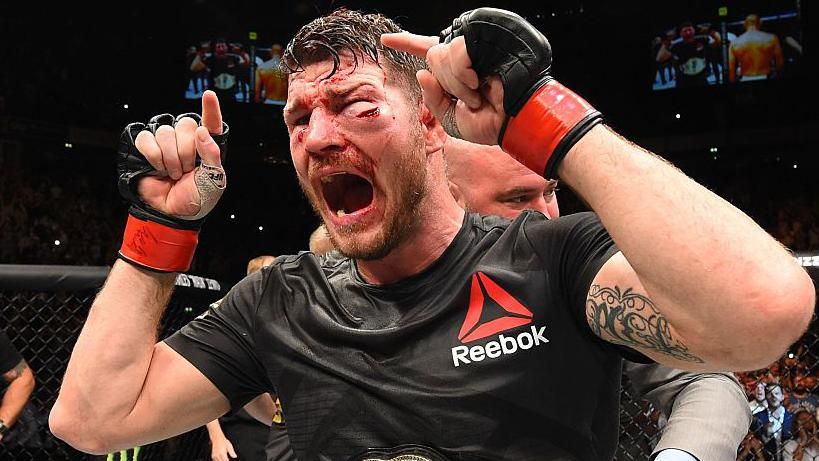 Michael Bisping is badly bruised and cut with the UFC title around his waist