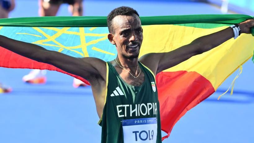 Tamirat Tola after winning the men's marathon at the Paris Olympics