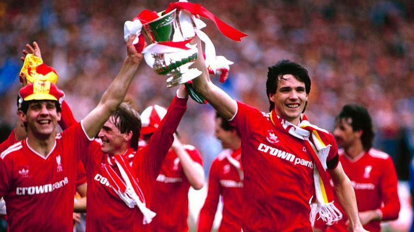 Liverpool players Jim Beglin and Alan Hansen parade the FA Cup trophy