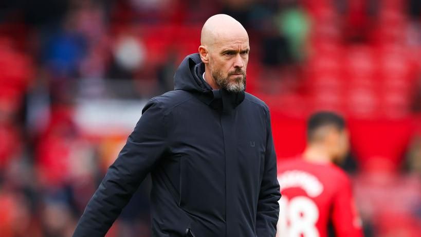 Erik ten Hag walks on the pitch after a Manchester United game