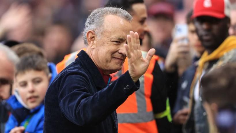 Tom Hanks waves to Aston Villa's fans before kick-off against Liverpool