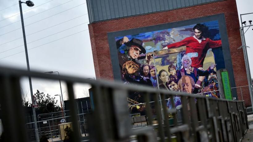 The Luminaries and Legends mural by artist Dee Craig highlighting cultural icons hailing from east Belfast including Van Morrison, George Best, CS Lewis, James Ellis and Gary Moore among others 