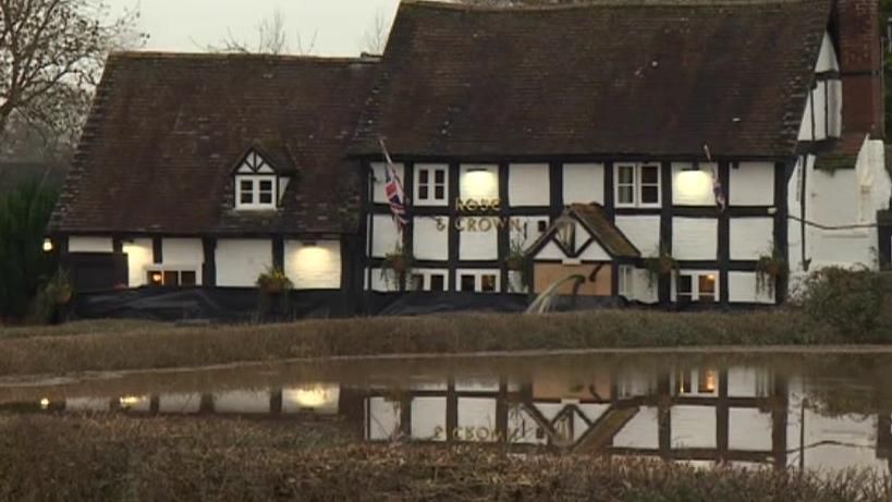 Rose and Crown pub in floodwater