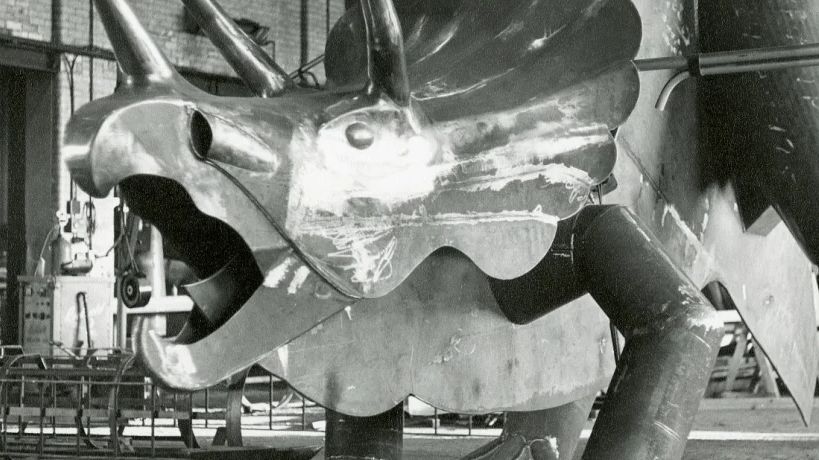 A steel dinosaur in a workshop