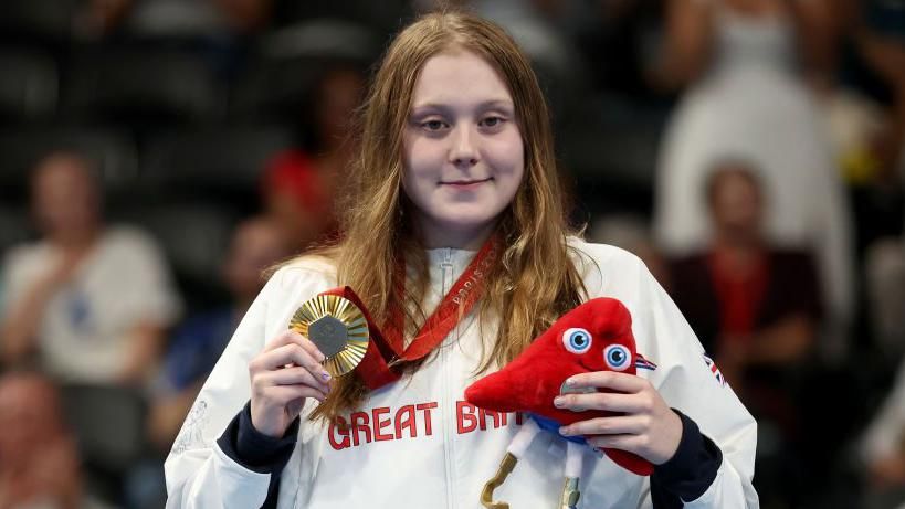 Para-swimmer Poppy Maskill with one of her gold medals