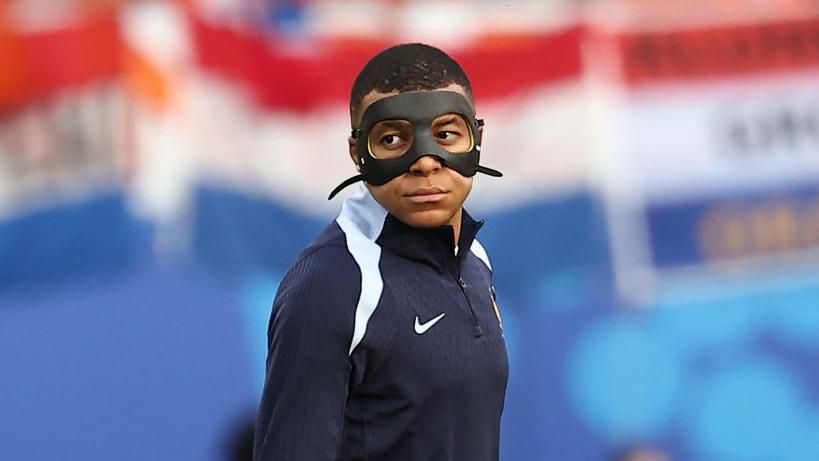 Kylian Mbappe wearing a mask during warm up