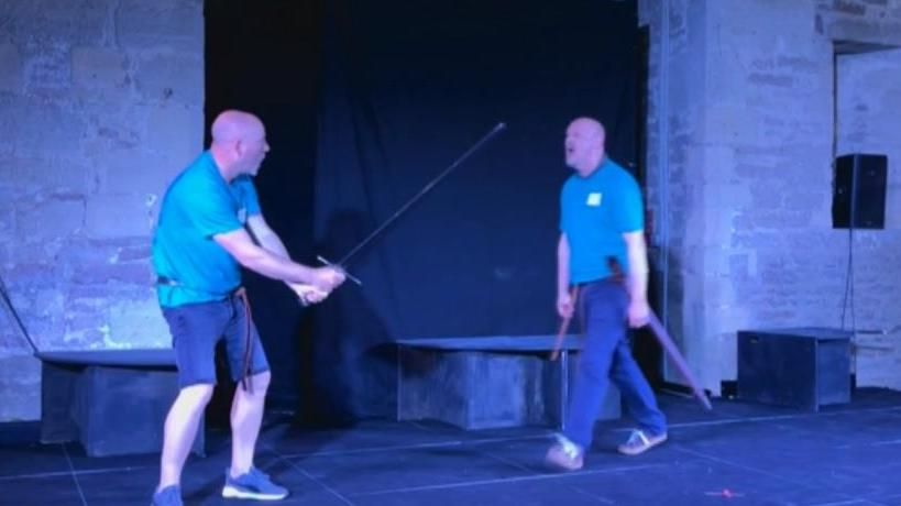 Martin Jessop and Lee Housely on stage practising a sword fight