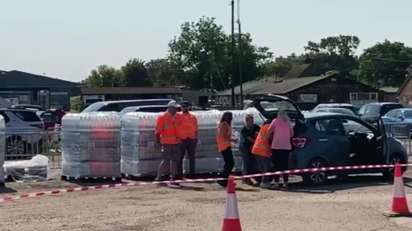 A car being filled with bottled water