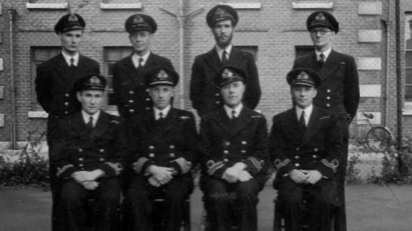 Boyd Salmon appears alongside seven other members of Royal Navy in military uniform 