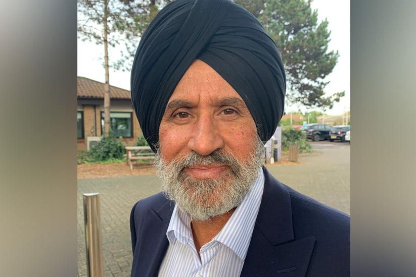Liberal Democrat candidate Jasbir Singh Parmar dressed in a shirt and suit