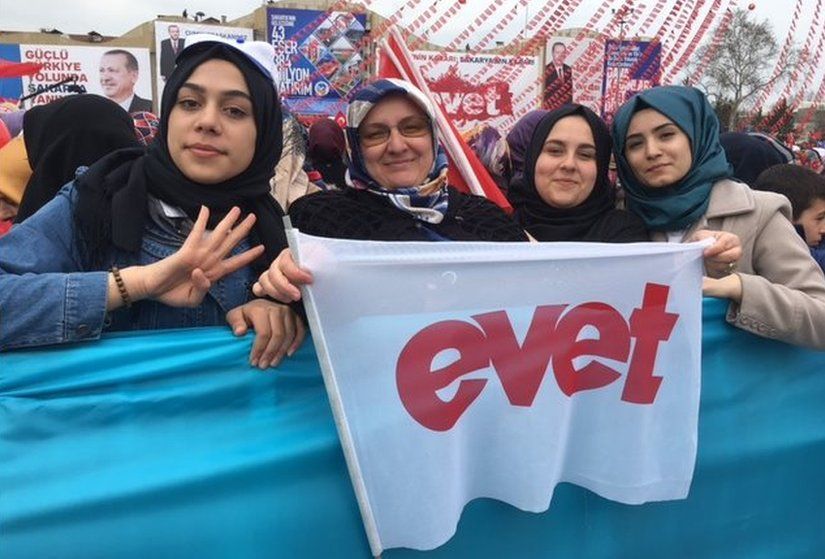 A picture of Kubra Husnan, Esma Koc and two other supporters waving a "yes" flag