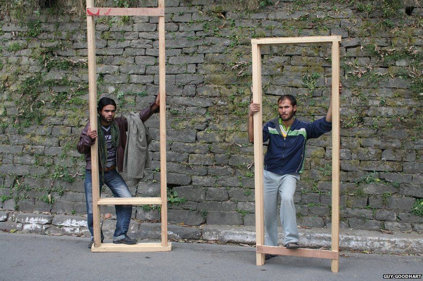 Two men with wooden frames