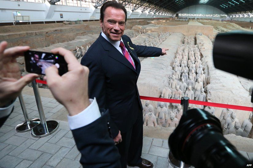 Actor and former California governor Arnold Schwarzenegger poses for a photo as he visits the Terracotta Warriors in Xian