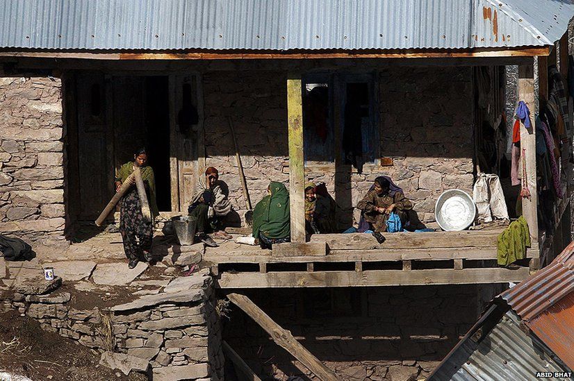 A Kashmiri Muslim family seen outside their home in Chauranda village close to the Line of Control.