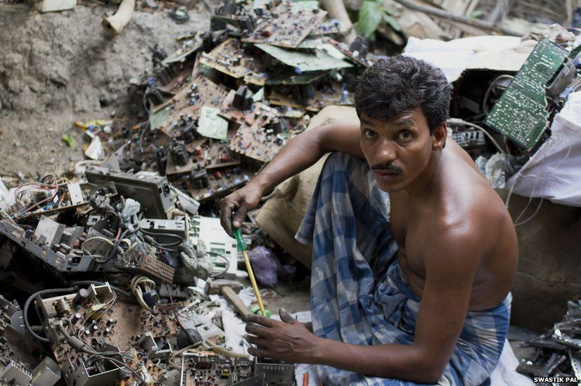 Hakim Naskar, 40, sits amidst a heap of E-waste in his courtyard. With no land to cultivate, this is his only source of income. He works more than fourteen hours every day to maximize his income.