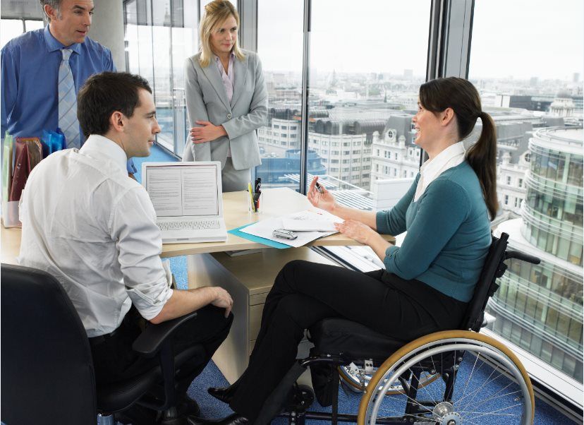 Office meeting with woman sitting in a wheelchair