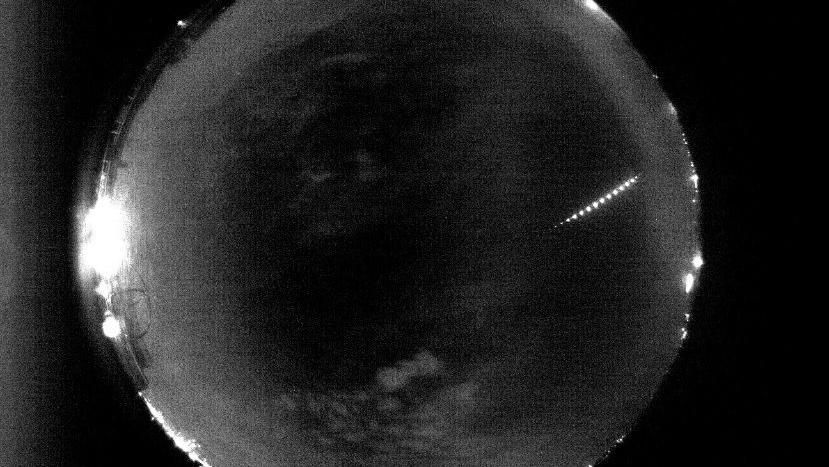 A darkened image of the earth with a beam of lighting crossing over it.