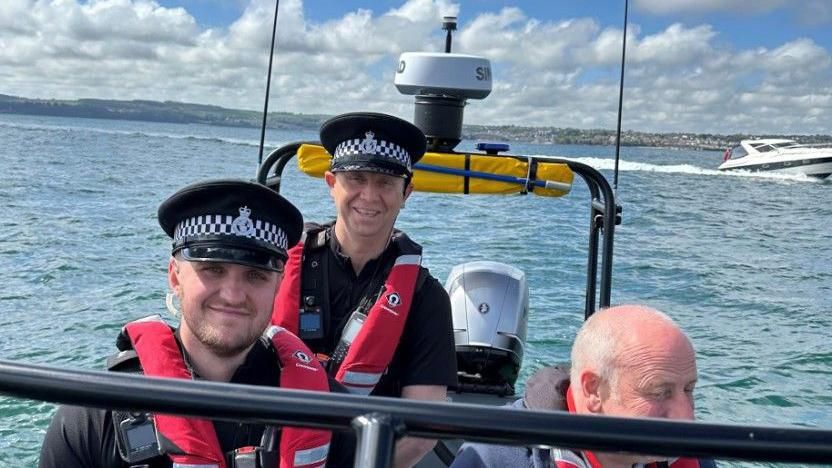 Police officers on a boat