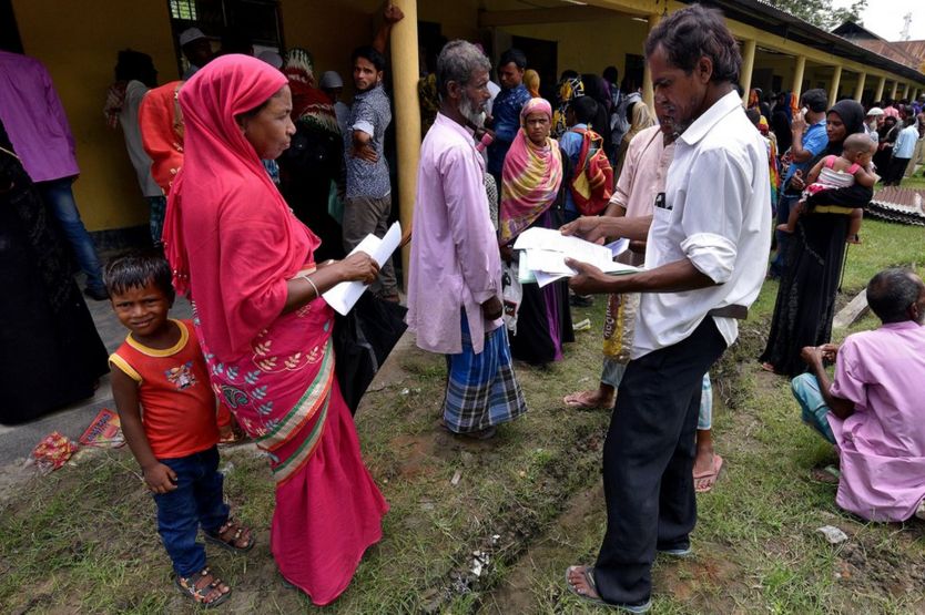 Villagers in Assam wait outside the National Register of Citizens (NRC) centre to get their documents verified by government officials.