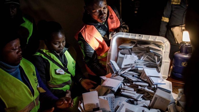 An election official opens a ballot box during the tally of the votes at a polling station for the general election in the suburb of Mbare of Zimbabwe"s capital Harare on July 30, 2018