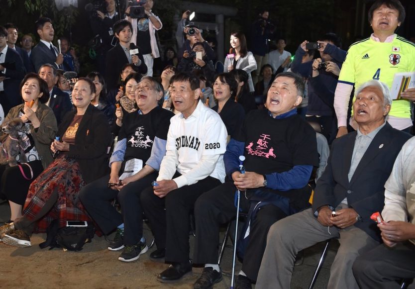 Fans of Japanese novelist Haruki Murakami react when the Swedish Academy awarded the Nobel prize for literature to US musician Bob Dylan at a shrine in Tokyo on 13 October 2016.