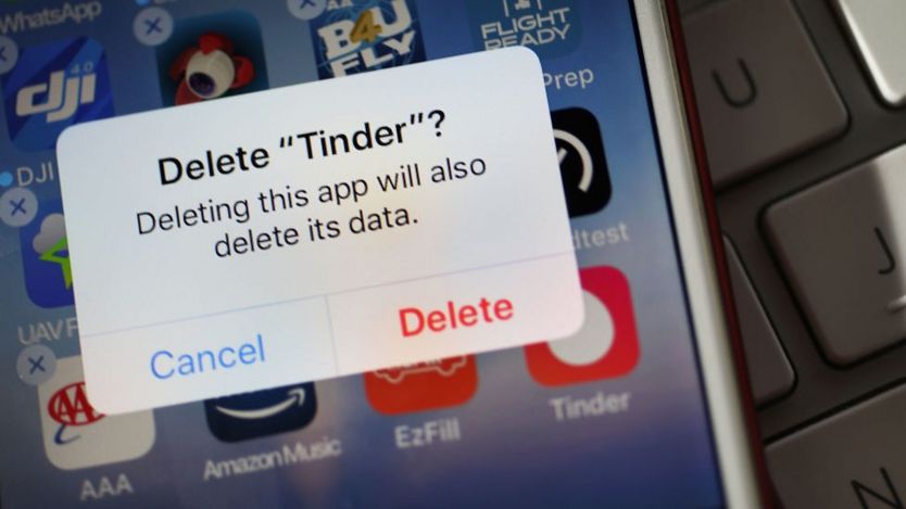 Smartphone screen with prompt to delete Tinder