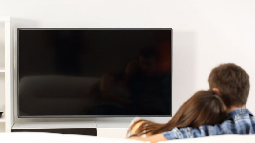 Couple looking at a black screen