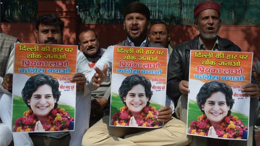 Congress party workers hold pictures of Priyanka Gandhi outside the party office in Delhi on February 10, 2015, demanding Priyanka replace Rahul Gandhi to save the party