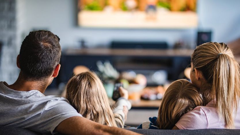 Family in front of big screen